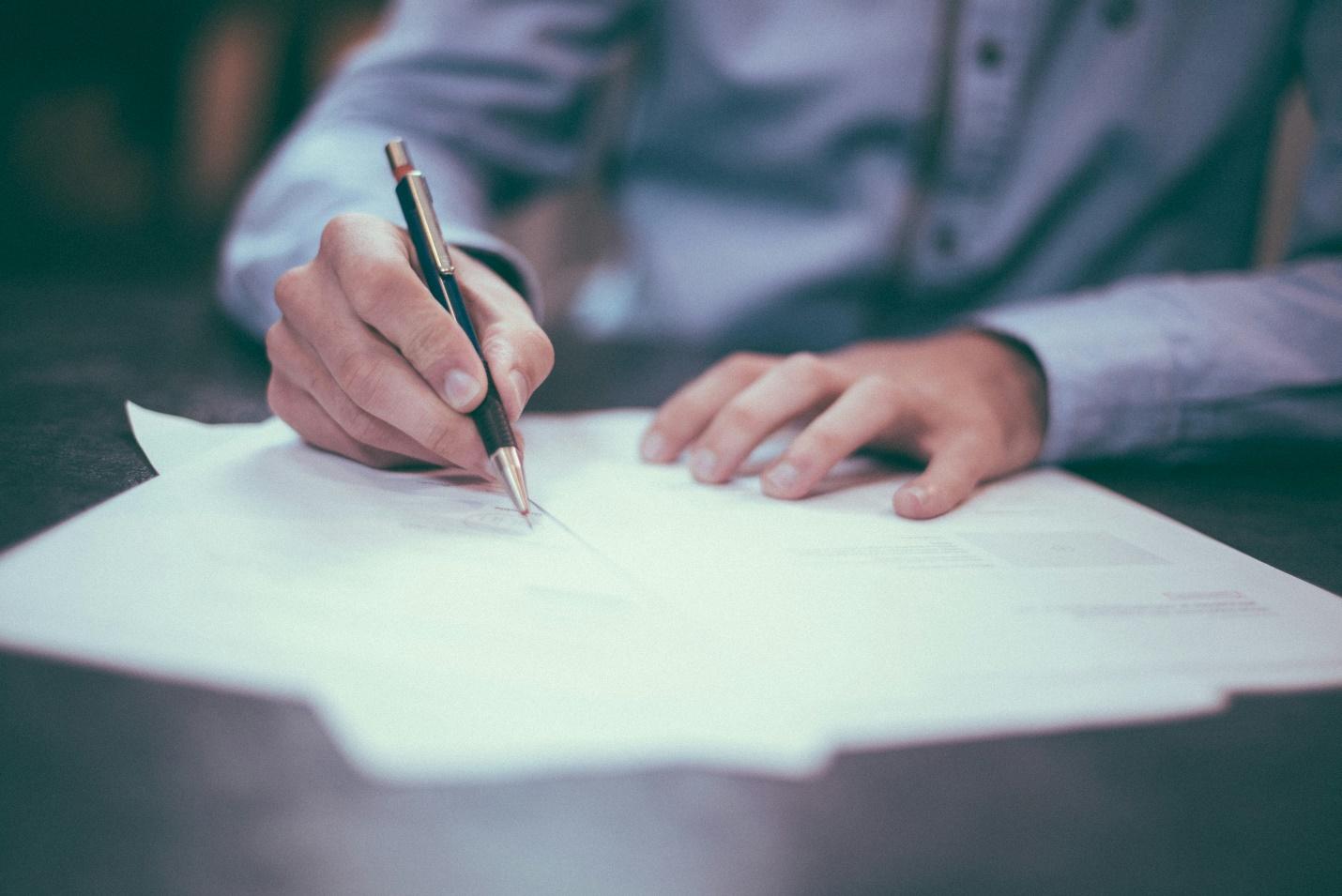 A man writing on a piece of paper