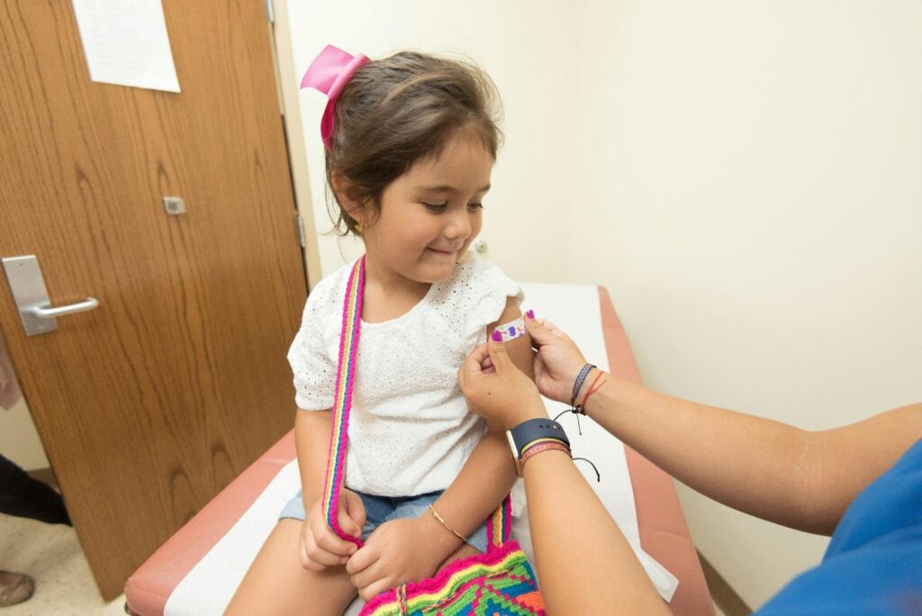 A little girl getting a band-aid