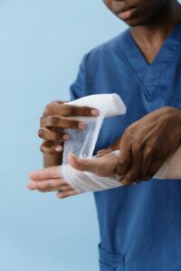 Healthcare professional applying gauze to a surgical wound