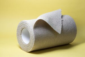 Sterile white gauze pad on a yellow background