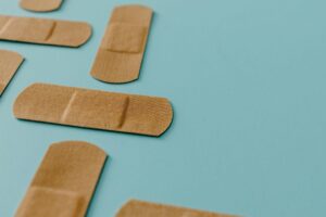 Several band aids laid out on a bright blue surface