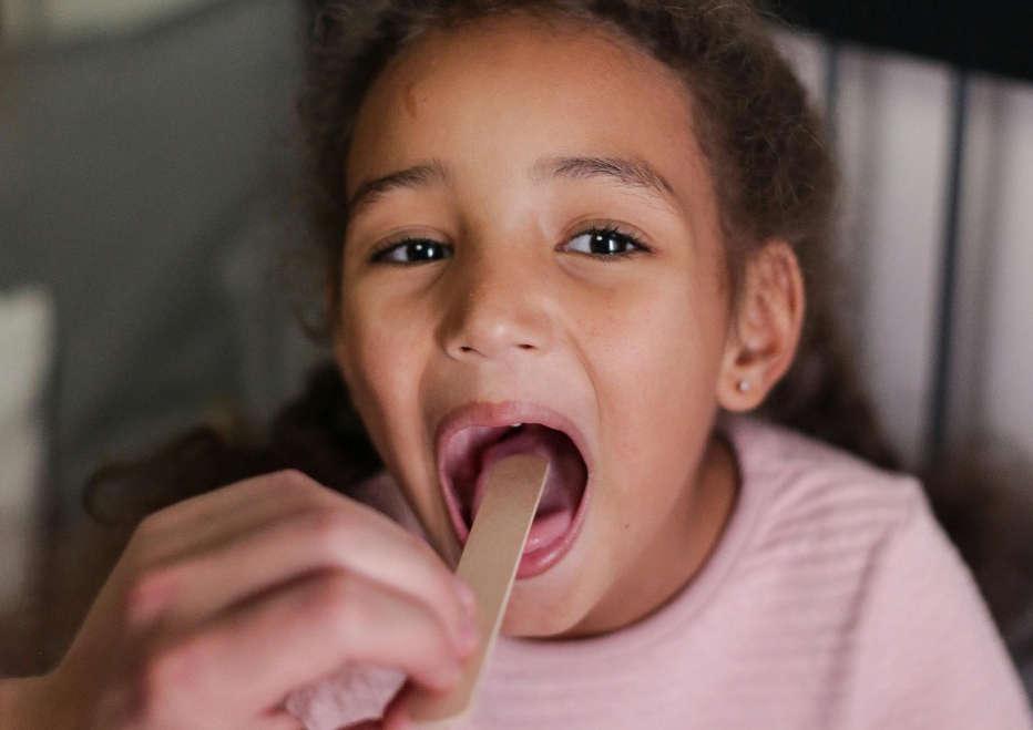 A little girl getting her throat checked