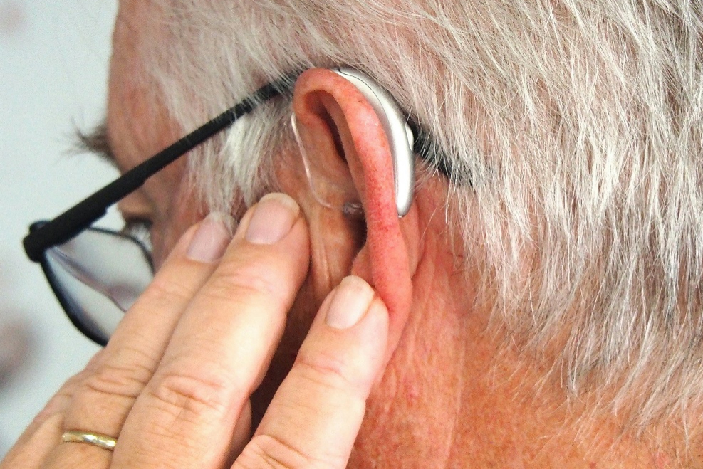Person tenderly touching their ear