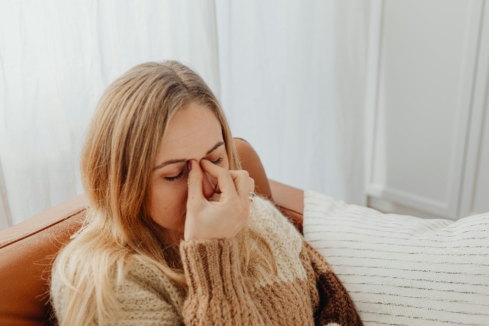 Woman pinching the bridge of her nose
