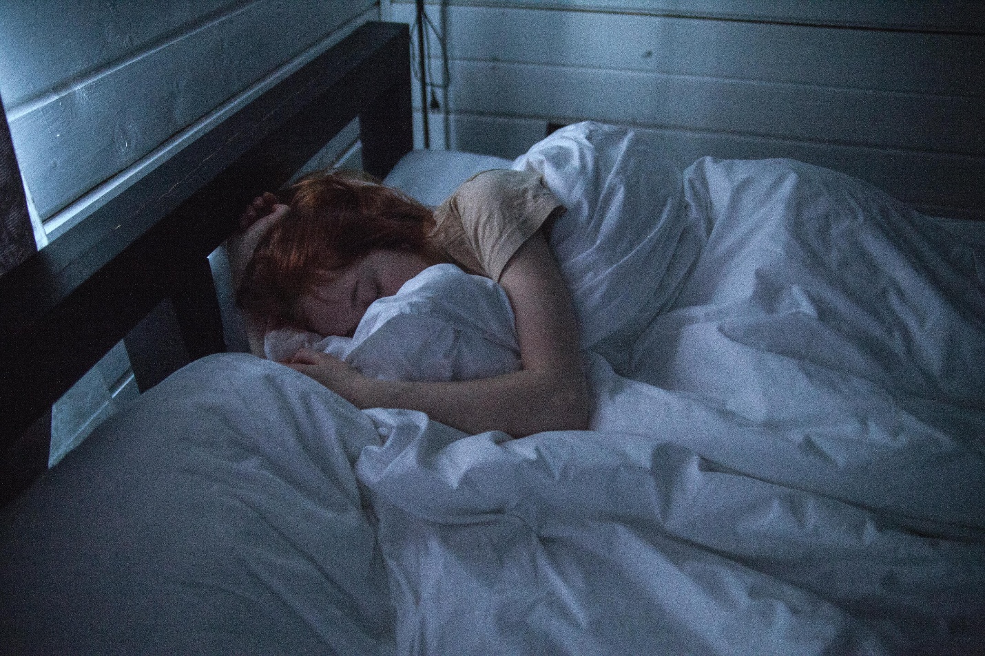 Woman sleeping in a cozy bed