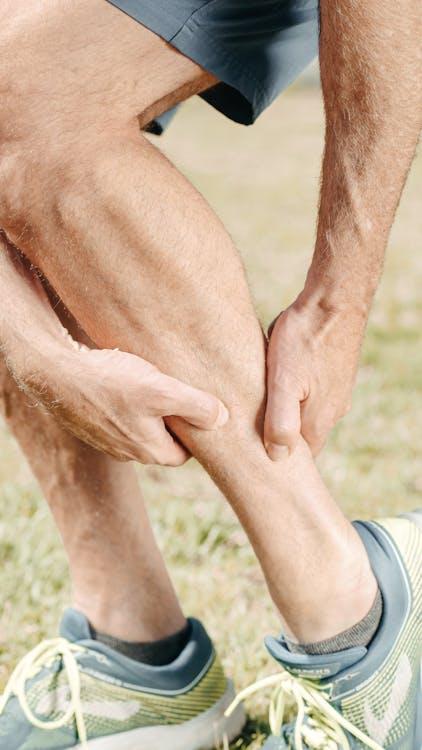 An image of a man massaging his calf
