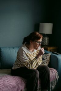 A woman coughing into her hand