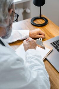 elderly doctor writing a prescription