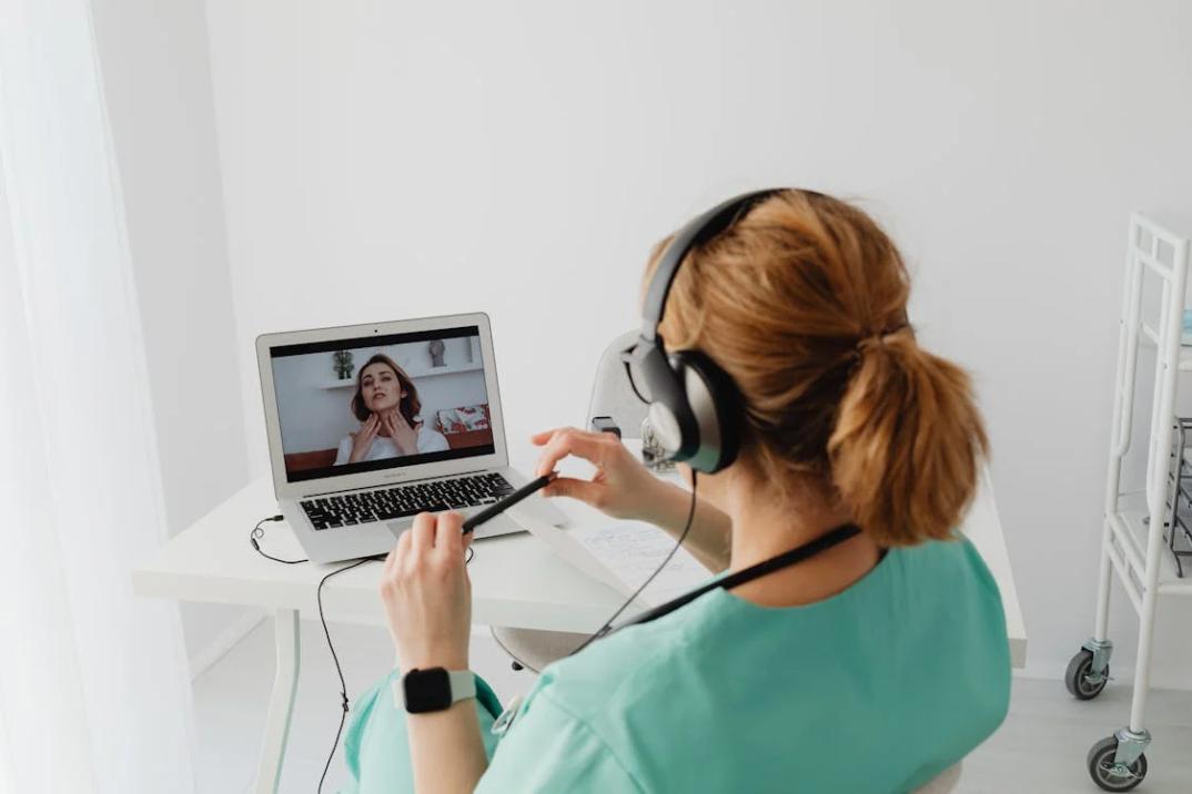 An image of a woman in an online session with a doctor