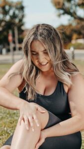 An image of a woman with knee pain after exercising