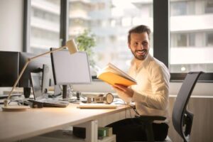 man holding book in office