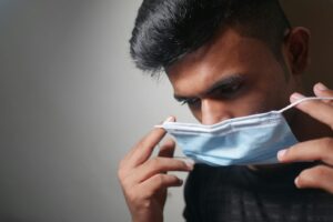A man putting on a face mask
