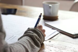 A person writing on paper 