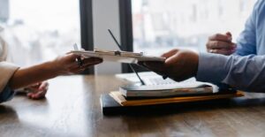 Worker submitting paperwork to HR for job-protected medical leave.