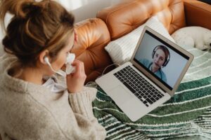 woman looking at laptop screen during online healthcare consultation