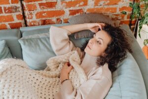 sick woman lying on sofa
