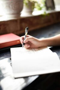 A person writing in a notebook