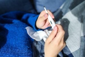 Checking fever with thermometer for safe fever management