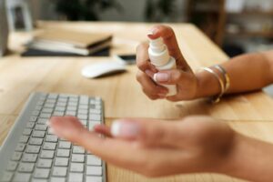 A person sanitizing their hands at work