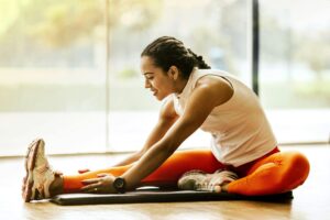 woman stretching on a mat after a workout session