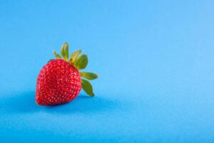 fresh strawberry on a blue surface