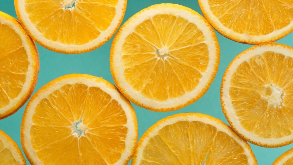 Close-up of sliced oranges arranged on a flat surface.