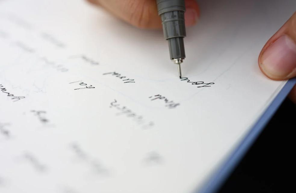 This image shows someone making notes on a paper