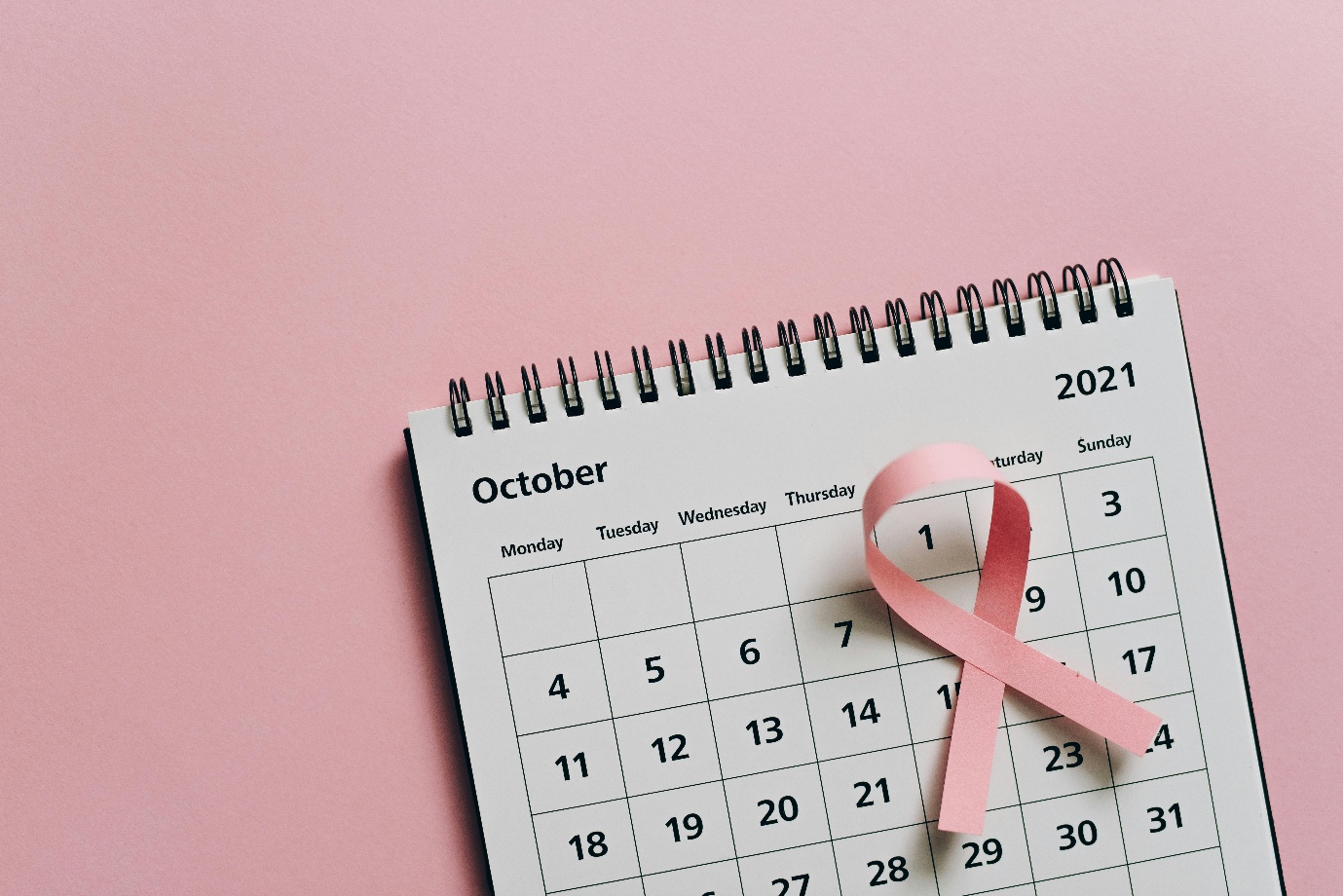 a pink ribbon on a calendar