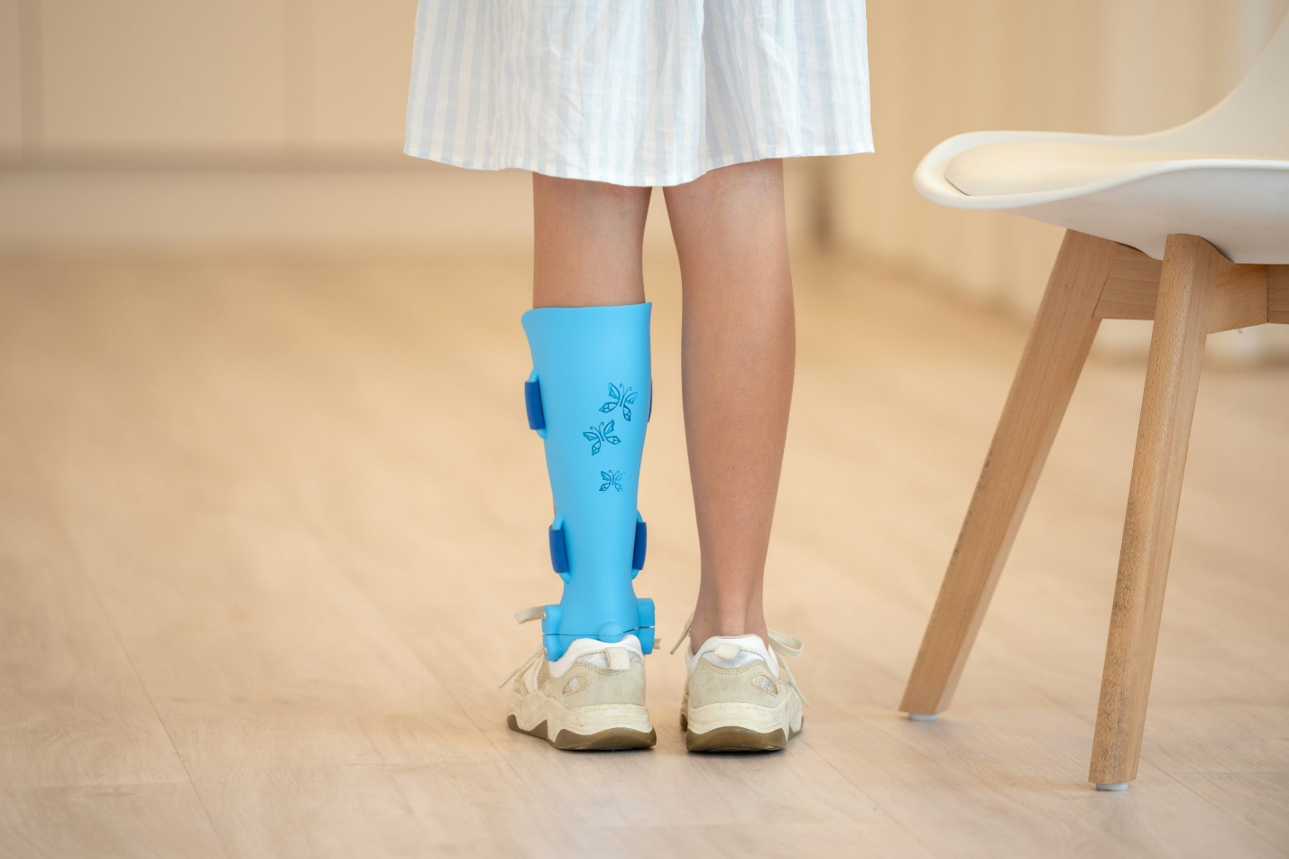 Person wearing an ankle brace to support recovery from a sprain