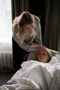 a boy lying on a couch.