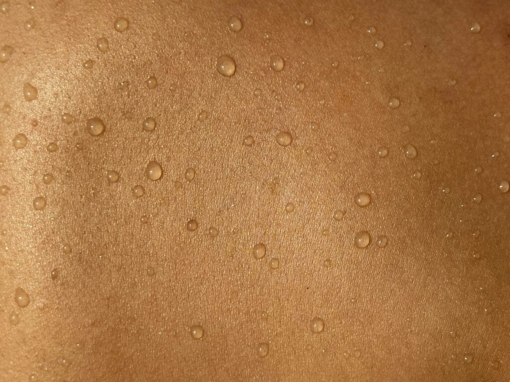 Close-up of small sweat blisters on skin consistent with heat rash