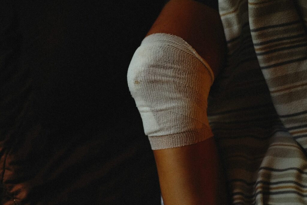 Close-up of a knee wrapped in bandage after a sprain injury