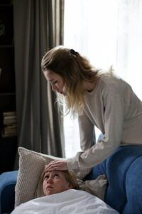 a woman sitting with her sick child.