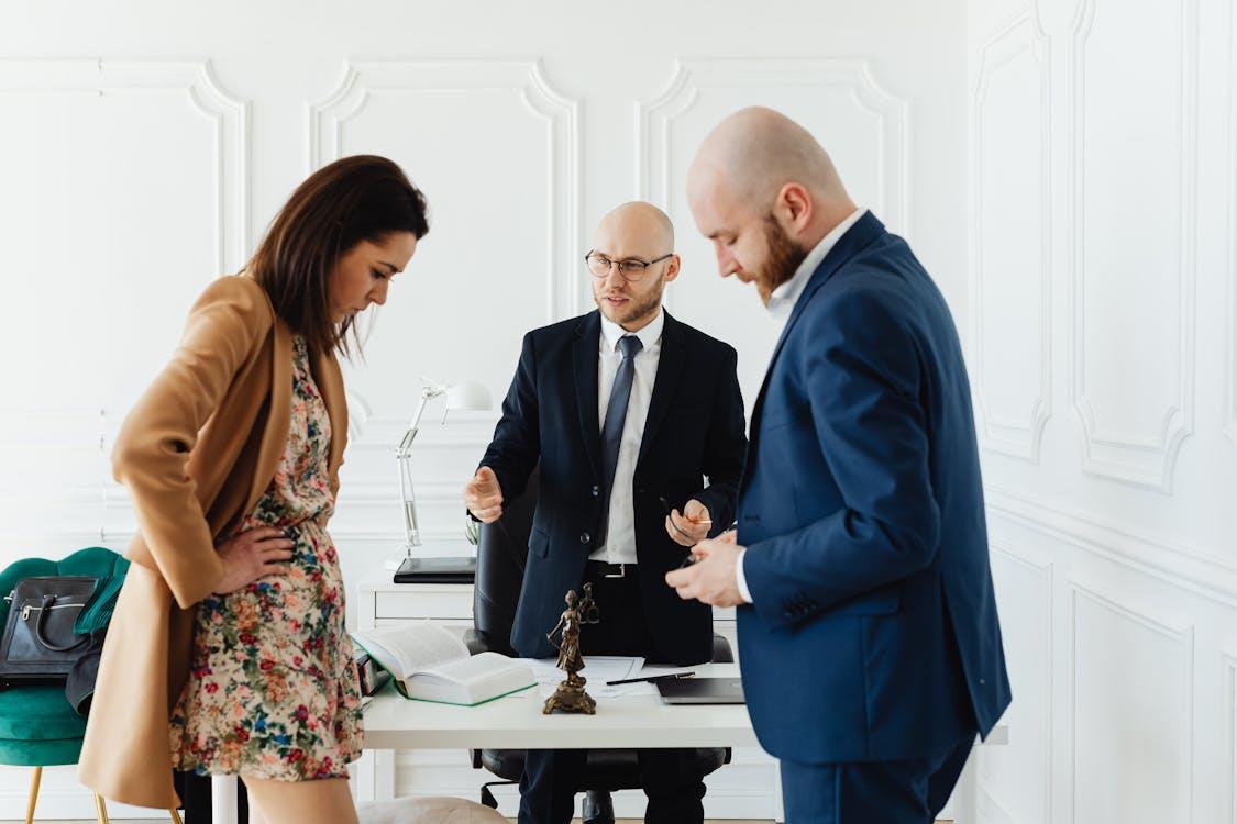 Man and woman standing and looking down at documents