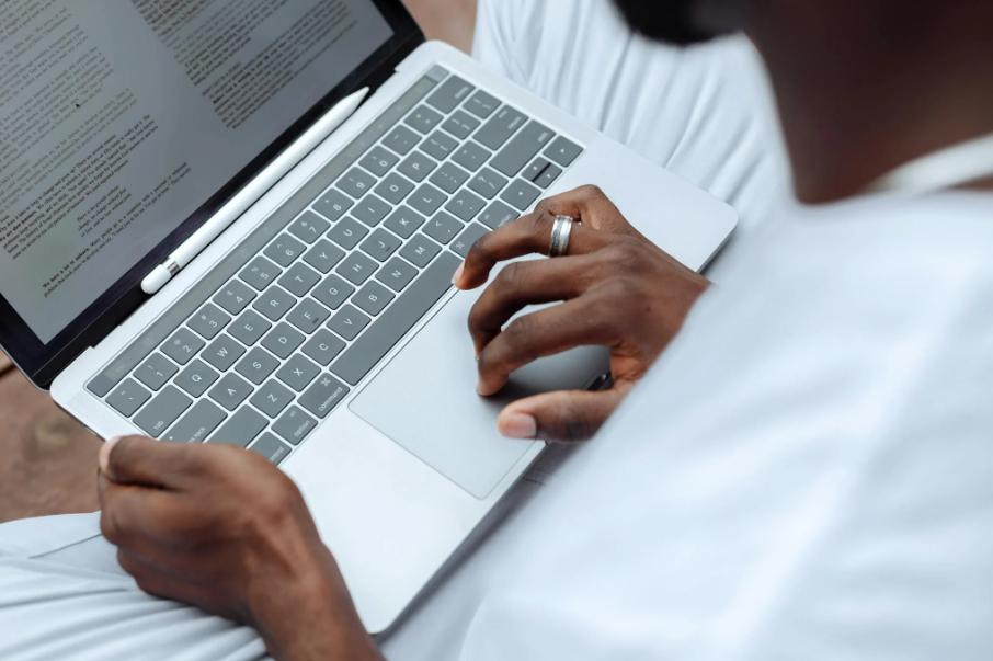 This image shows a person is writing digital sick note on laptop.