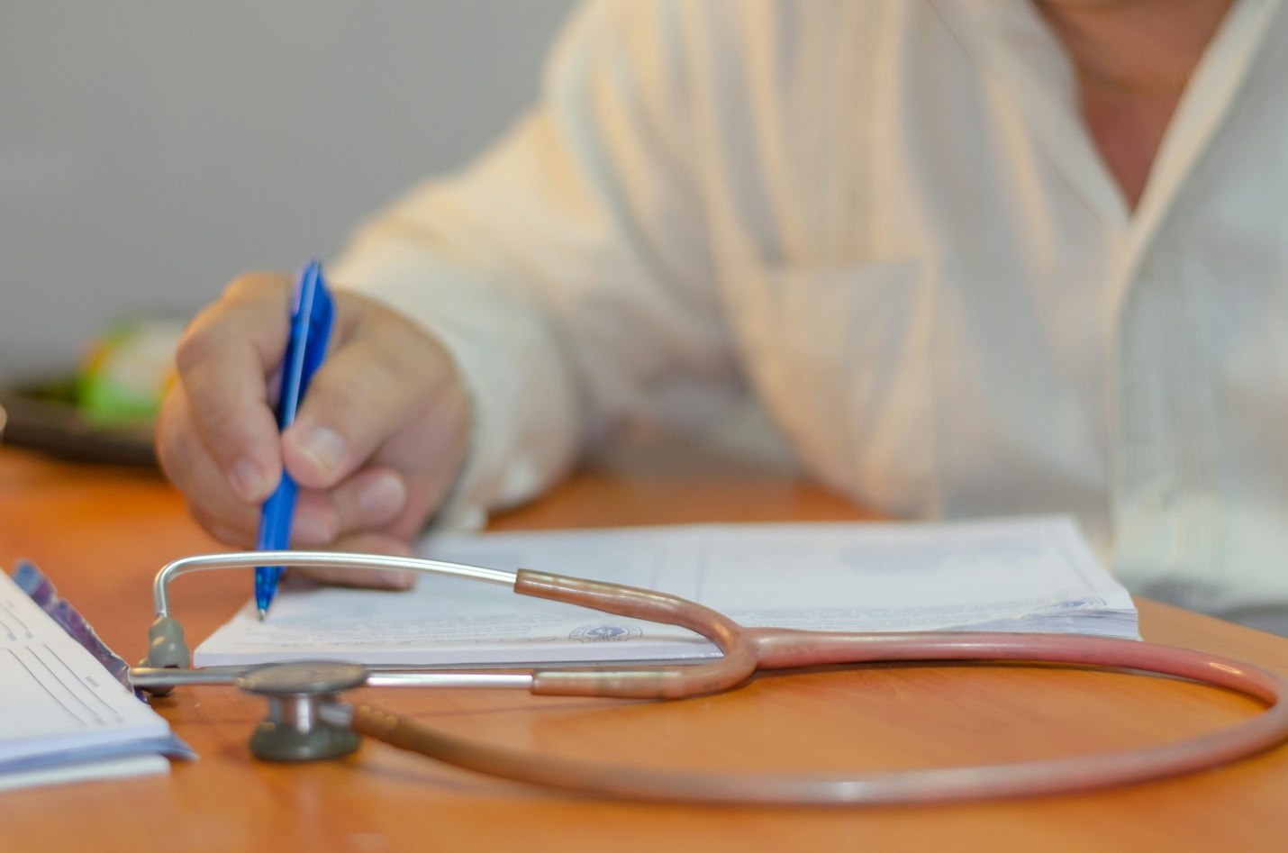A doctor writing on a piece of paper 
